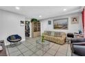 Living room with tile flooring, a couch, armchairs, and a small coffee table at 6109 Empire Cir, Las Vegas, NV 89107