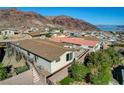 Elevated view of a home with a staircase, showcasing the roof and backdrop of the desert mountains at 623 Mount Elbert Way, Boulder City, NV 89005