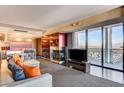 Modern living room with city views, fireplace, and sleek furnishings at 4381 W Flamingo Rd # 3002, Las Vegas, NV 89103