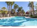 Relaxing community pool surrounded by palm trees at 8455 W Sahara Ave # 287, Las Vegas, NV 89117