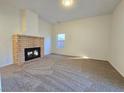 Bright living room with a brick fireplace and neutral carpeting at 1636 Lorna Dr, Henderson, NV 89011