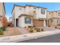 Two-story house with tan exterior, blue shutters, and landscaping at 4615 Adonis Blue St, North Las Vegas, NV 89031