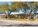 House exterior showcasing a landscaped yard and large trees at 917 Bonita Ave, Las Vegas, NV 89104