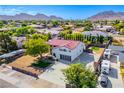 Aerial view of a remodeled home with a large yard, showcasing a modern garage and landscaping at 1571 Sundown Dr, Henderson, NV 89002