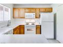 White appliances and wood cabinets in a galley kitchen at 4555 E Sahara Ave # 223, Las Vegas, NV 89104