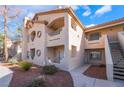 Building exterior showcasing a two-story design, stairs, and landscaping at 5415 W Harmon Ave # 1051, Las Vegas, NV 89103