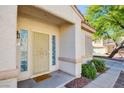 Inviting front door with a welcoming mat and sidelights at 7741 Orchard Wood Ct, Las Vegas, NV 89131