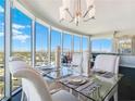 Bright dining room with glass table, white chairs, and expansive city views at 322 Karen Ave # 1207, Las Vegas, NV 89109