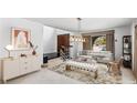 Bright and airy living room with a neutral color palette and large windows at 7335 Edna Ave, Las Vegas, NV 89117