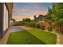 Landscaped backyard with artificial turf and paved patio at 90 Einstein Ridge Way, Las Vegas, NV 89183