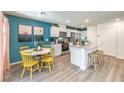 Modern kitchen with island, white cabinets, and teal accent wall at 9368 Serene Harbor St # Lot 30, Las Vegas, NV 89178