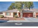 Single-story home with red garage door and mature tree in front at 1016 Chestnut Bay Ave, North Las Vegas, NV 89031