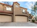 Tan two-story home with two-car garage and balcony at 500 Sutters Mill Rd, Henderson, NV 89014