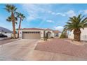 Single-story home with desert landscaping and two-car garage at 411 Opal Dr, Henderson, NV 89015