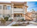 Condo building showcasing a two-story design, balconies, and desert landscaping at 7905 Esterbrook Way # 101, Las Vegas, NV 89128