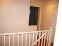 Upstairs hallway with white railing and access to bedrooms at 3367 Villa Fiori Ave, Las Vegas, NV 89141