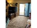 Living room with TV, couches, and sliding glass door at 427 E Barrett St, Henderson, NV 89011