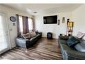 Living room with dark leather couches and wood-look floors at 5330 E Charleston Blvd # 5, Las Vegas, NV 89142