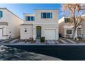 Two-story house with attached garage, front yard and walkway at 9927 Keephills St, Las Vegas, NV 89183