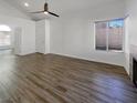 Bright living room featuring hardwood floors and a ceiling fan at 1658 Garden Path Ct, Las Vegas, NV 89119