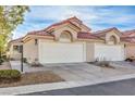 Front view of two-car garage, Spanish style home at 7801 Oakstone Ct, Las Vegas, NV 89145