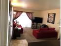 Spacious living room, featuring plush sofas and a large TV at 3046 Tarpon Dr # 103, Las Vegas, NV 89120