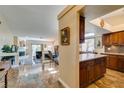 Open kitchen with granite countertops and dark wood cabinets at 3816 Sunking St, Las Vegas, NV 89130