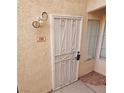 Front door entry with security gate and address number 104 at 6821 Santa Isabel Ave # 104, Las Vegas, NV 89146