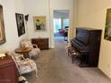 Cozy sitting area with antique piano and comfortable chairs at 143 Kava Kava St, Henderson, NV 89015