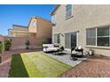 Spacious backyard with grass, patio, and seating area at 7727 Moore Creek Ln, North Las Vegas, NV 89084