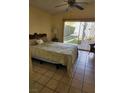 Bright bedroom with tiled floors and sliding glass doors leading to the backyard at 8228 Lauderdale Ct, Las Vegas, NV 89128