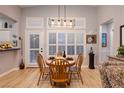 Bright dining area with wood floors and a charming wooden table at 10525 Shanna Trellis Ave, Las Vegas, NV 89144