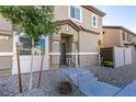 Front entrance of townhome with stairs and landscaping at 4735 Blaise Ave # 102, North Las Vegas, NV 89084