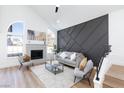 Open living area with modern fireplace and geometric accent wall at 1932 Misty Glade Dr, Las Vegas, NV 89119