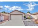 Single-story house with a beige exterior, attached garage, and landscaped front yard at 2157 Point Mallard Dr, Henderson, NV 89012