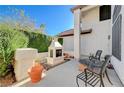 Relaxing patio featuring a fireplace and lush greenery at 363 Rushing Creek Ct, Henderson, NV 89014