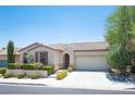 Single-story house with tan exterior, brown roof, and landscaped front yard at 9343 Oxbow Lake Ave, Las Vegas, NV 89149