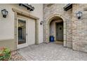 Inviting entryway with brick facade and landscaping at 445 Venticello Dr, Las Vegas, NV 89138