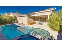 Inviting kidney-shaped pool with a spa and covered patio at 8133 Shady Glen Ave, Las Vegas, NV 89131