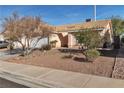 Tan one-story house with attached garage and mature trees in the front yard at 918 Ambusher St, Henderson, NV 89014