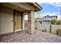 Inviting front entry with a modern door and paved walkway at 9702 Sapphire Rim Ave, Las Vegas, NV 89148