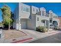 Two-story house with balcony, attached garage, and front yard landscaping at 10324 Midseason Mist St, Las Vegas, NV 89183