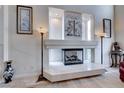 Elegant living room fireplace with marble surround and modern gas insert at 10681 Wildhurst St, Las Vegas, NV 89183