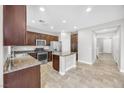 Spacious kitchen with granite countertops and dark wood cabinets at 10822 Drake Ridge Ave, Las Vegas, NV 89166