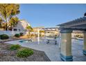 Community pool with pergola and seating area at 4966 Droubay Dr, Las Vegas, NV 89122