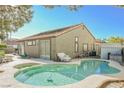 Relaxing kidney-shaped pool in backyard oasis at 1424 Country Hollow Dr, Las Vegas, NV 89117