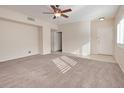 Spacious living room with neutral carpet and ceiling fan at 2053 Quarry Ridge St # 106, Las Vegas, NV 89117