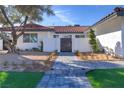 Front entrance with a walkway, landscaping, and a modern wooden gate at 8901 Dio Guardi Dr, Las Vegas, NV 89117