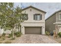 Two-story house with brown garage door and landscaped front yard at 10558 El Camino Rd, Las Vegas, NV 89141