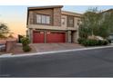 Modern two-story house with red double garage doors at 6407 Carmel Creek Ave, Las Vegas, NV 89139